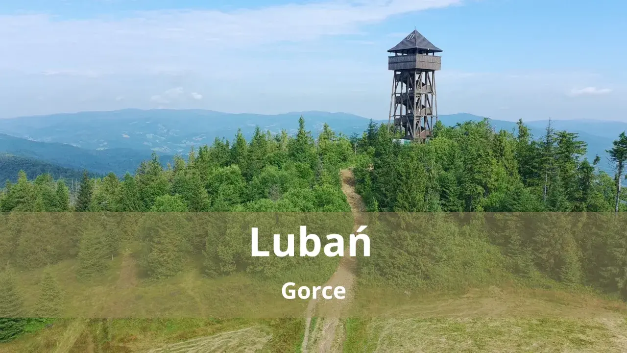 Wieża widokowa na górze Lubań w Gorcach, otoczona zielonymi lasami i pagórkami.