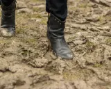 Czarne buty w błocie, po spacerze po deszczu. Czas dowiedzieć się, jak wyczyścić buty z błota, by znów lśniły.
